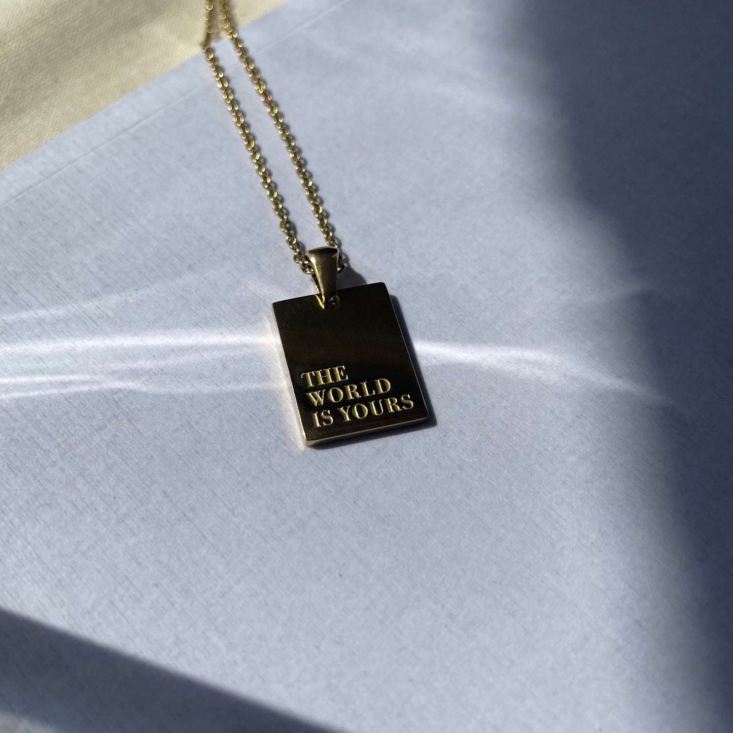The World Is Yours Gold Pendant Necklace