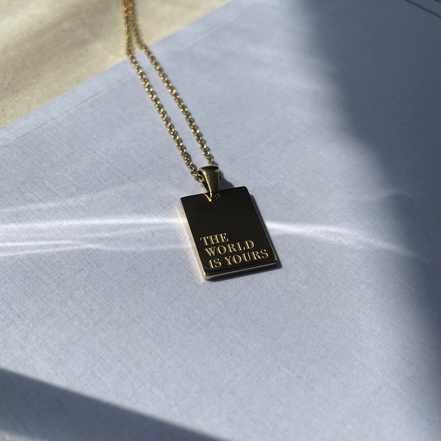 The World Is Yours Gold Pendant Necklace
